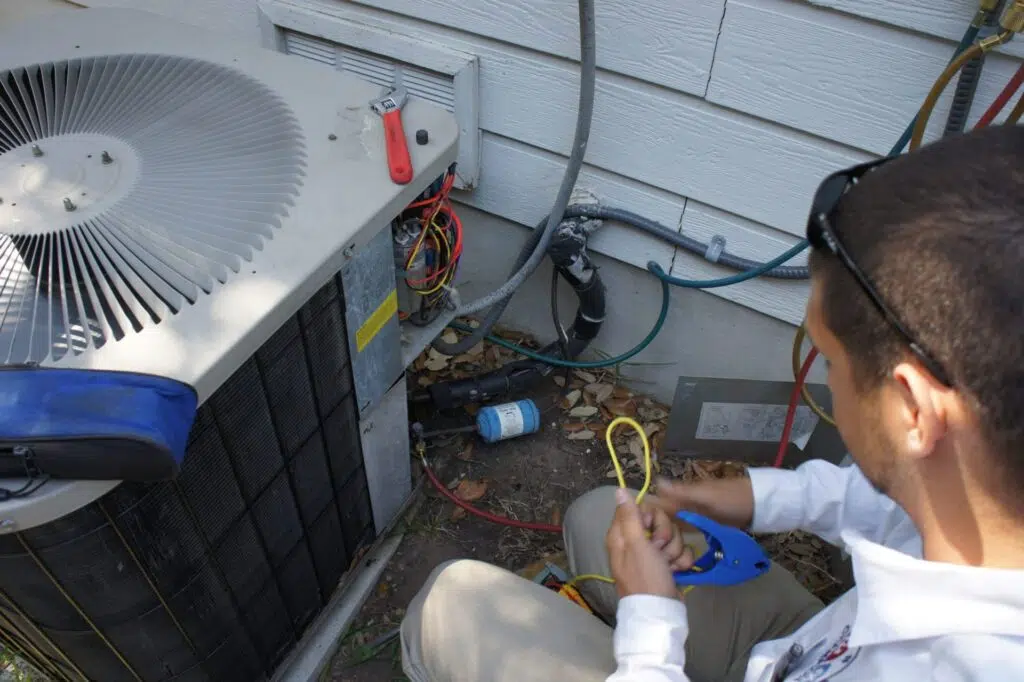 HVAC/R technician servicing a home heating and cooling system