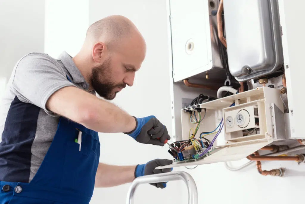 Technician performing industrial boiler maintenance